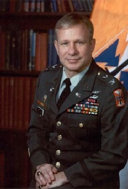 A man in military uniform sitting on top of a table.